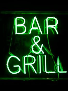 close up of bar and grill neon sign