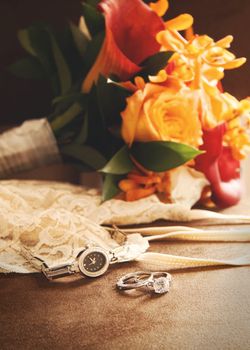 Wedding ring with bouquet on velvet chair