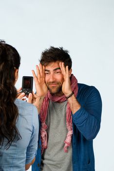 Happy loving couple having fun taking photos of themselves