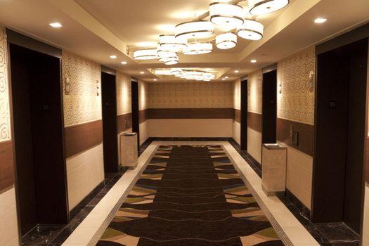 A hotel elevator lobby that leads to the hotel rooms