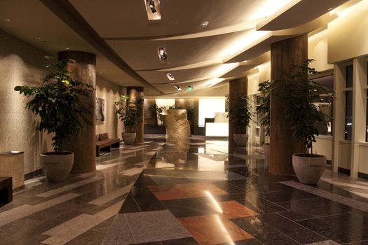  An empty modern hotel lobby with a granite floor