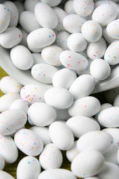 Miniature speckled easter eggs in a green bowl