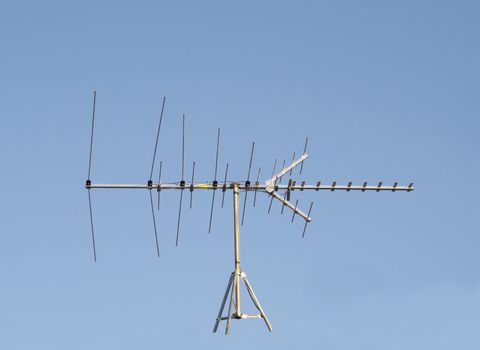 Uhf Vhf Television Antenna Isolated against a blue sky to put on whatever you like!