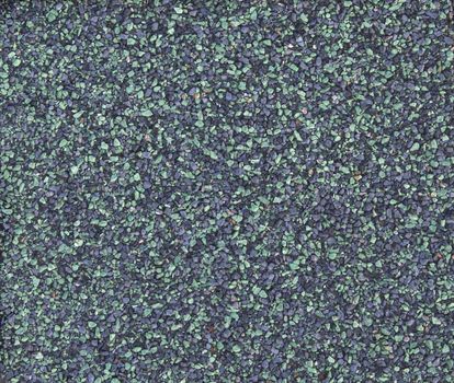 A macro of the stones of a green asphalt shingle