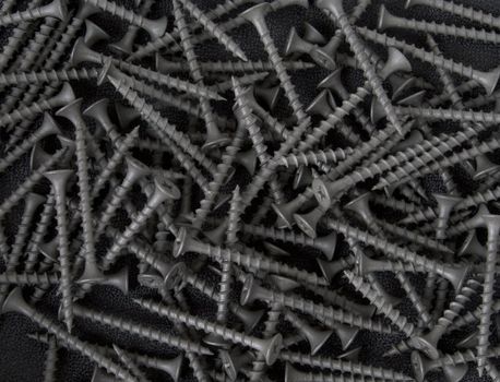A background or texture of black drywall screws