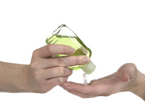 Woman squeezing green hand sanitizer lotion onto her hands.