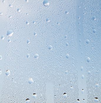 Water droplets in front of a blue sky background