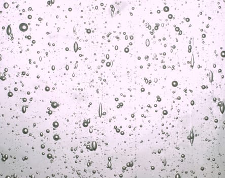 Abstract background of bubbles suspended in clear glass