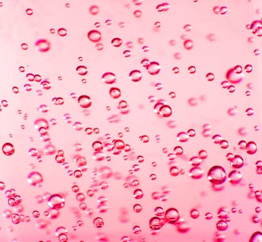 Bubbles suspended in a very vibrant red gel