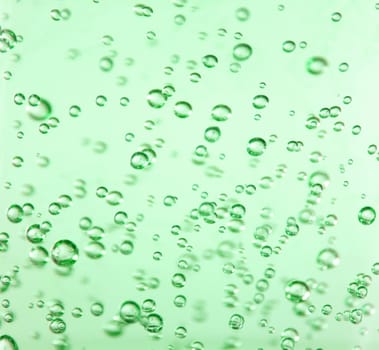 Bubbles suspended in a very vibrant green gel