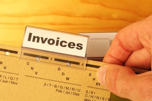 invoice or invoices concept with business folder in office showing paperwork