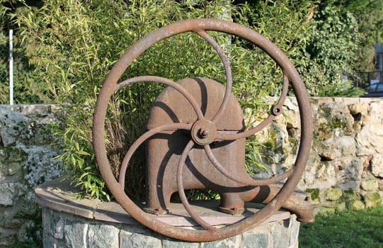 old water pump has become a decorative item in a city: symbole of the past
