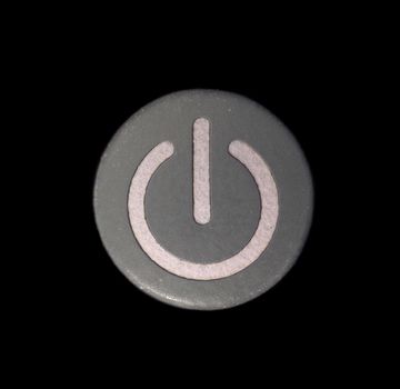 Macro of a Grey Colored Power Button Isolated on Black