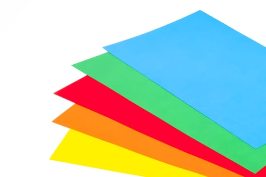 Five stacked colorful sheets on white background 