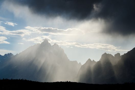 Rays of light, storm clouds and the Teton Mountains, Grand Teton National Park, Wyoming, USA