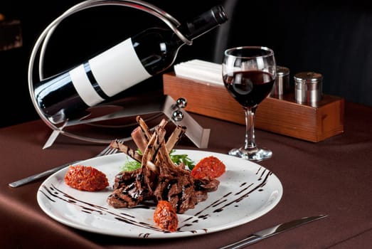 Roasted lamb chops with vegetables on decorated table