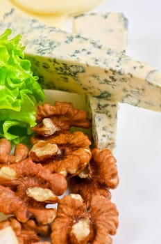 cheese with lettuce, grapes and nuts closeup