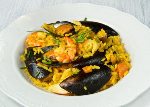 Close-up of Spanish paella on white plate