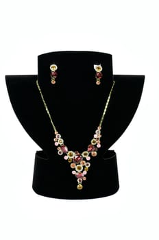 a necklace with pendants and earrings on a white background