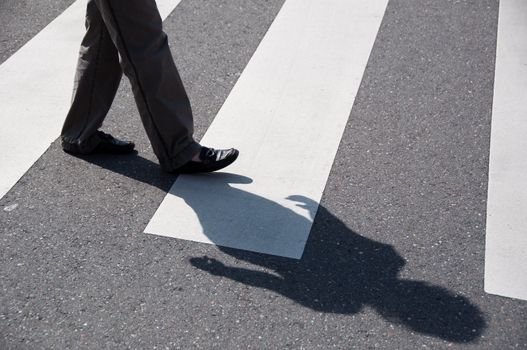 Female crossing the street using a zebra crossing and posing great shadows