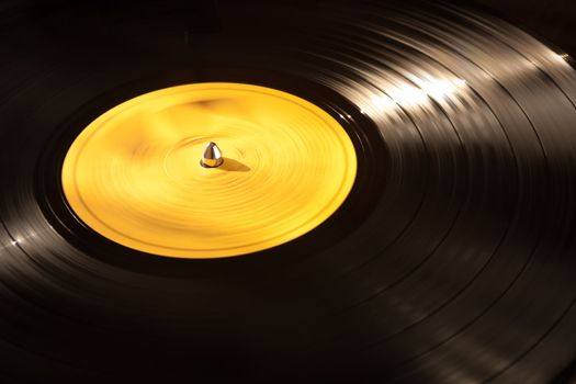 An old vinyl LP playing on a turntable. Good background for music designs.