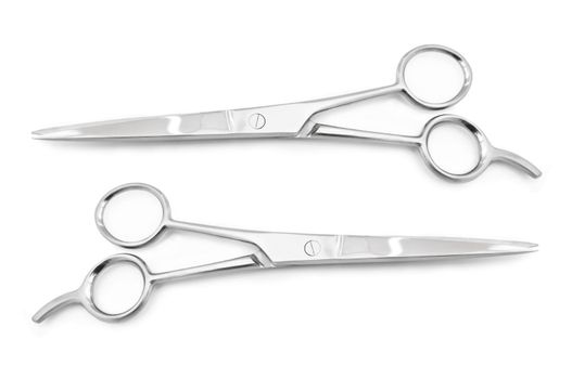 Two sets of stainless steel hairdressing scissors arranged horizontally and parallel to one another over white