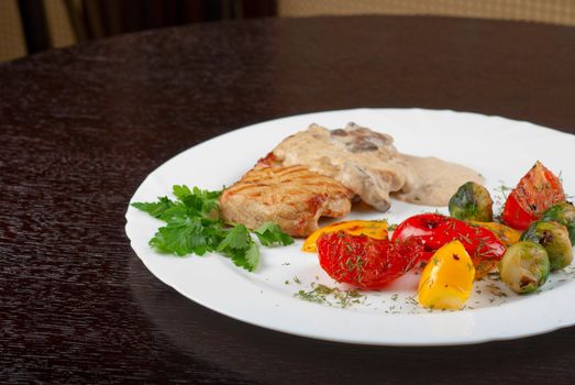 pork steak with mushroom sauce and grilled vegetables