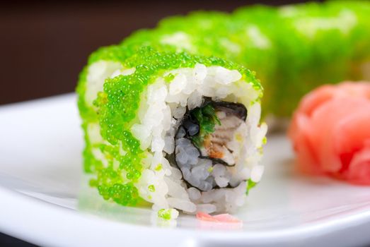 Sushi rolls made of salmon, avocado, flying fish roe - tobiko caviar and philadelphia cheese