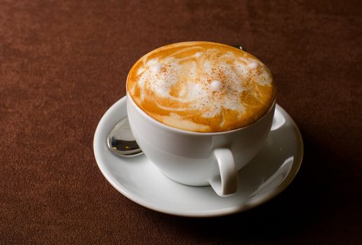 Cappuccino coffee cup closeup at the table