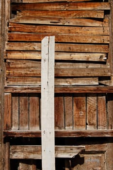 Boarded up old wooden door blocking the entrance to an abandoned house.