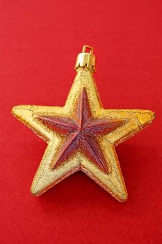 Christmas decoration. Golden star on red background.