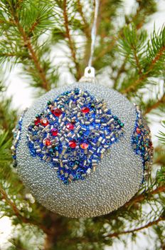 Christmas bauble hanging from a small tree.