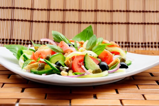 Fresh vegetable salad with basil, capers, olives, marinated with croutons

