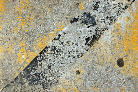 Concrete sidewalk with yellow and black paint.