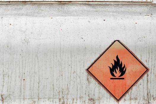 Flammable material weathered warning sign background. Fuel tank.