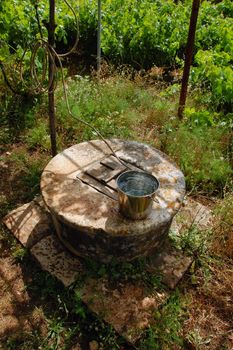 Traditional old stone well in a vineyard plantation in Zakynthos, Greece. Fresh water.