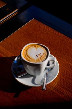 Cappuccino coffee cup closeup at the table