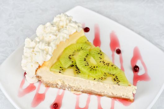 tasty kiwi fresh cake closeup at plate