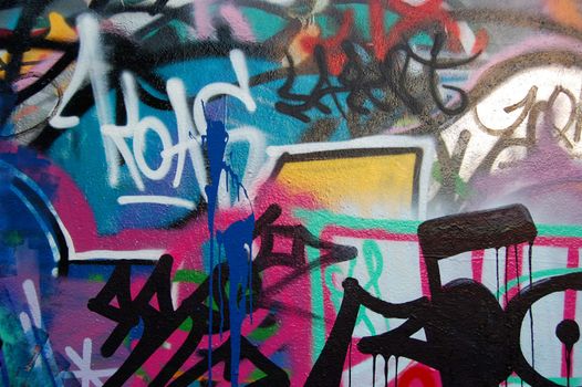 A wall covered with graffiti and tags.