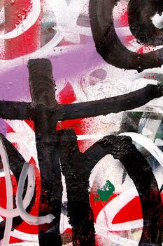 A surface covered with layers of graffiti and tags.