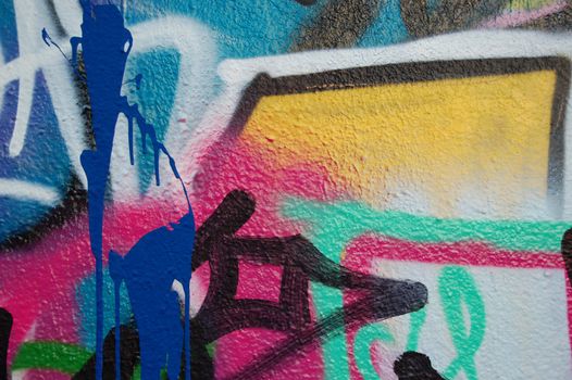 A wall covered with graffiti and tags.