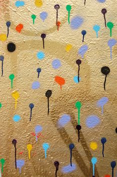 Detail of a wall covered with dots. Dripping paint. Graffiti street art.