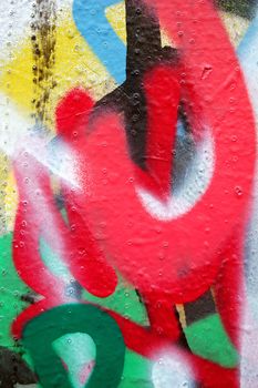 Detail of a wall covered with layers of graffiti.