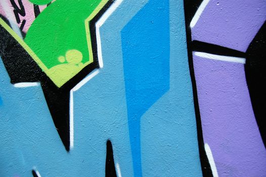 Detail of wall surface covered with graffiti and tags.