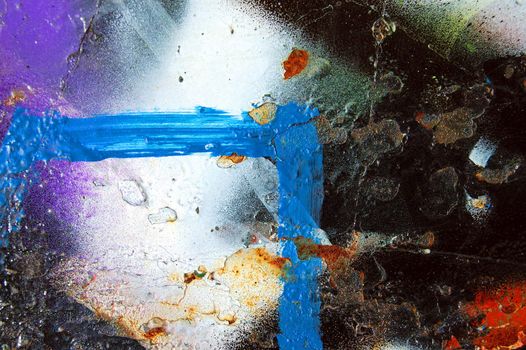 A metal surface covered with graffiti. Paint spray abstract background.