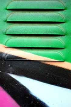 Detail of a metal surface covered with graffiti.