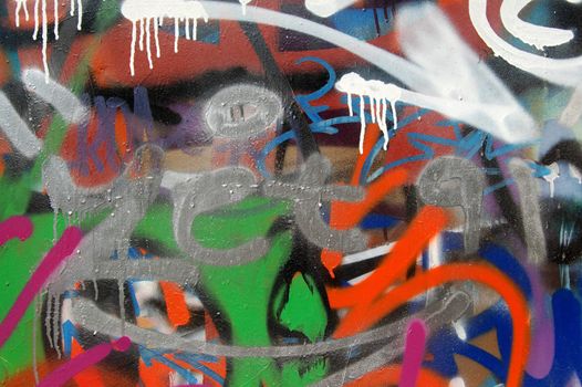 A wall covered with graffiti and tags. Colorful background.