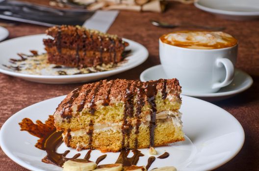 Dessert cakes with banana and coffee at table