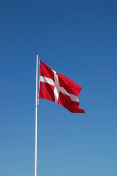 Danish flag against blue sky