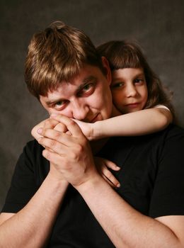 Double portrait. The daughter embraces the father